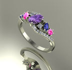 Side profile of the 18ct white gold Atlantis Storm ring, showcasing the wave-inspired setting and multi-coloured sapphire cluster.