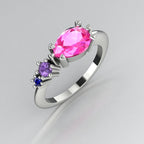 Pear shaped pink sapphire, violet sapphire and blue sapphire asymmetrical Comet engagement ring in 18ct white gold, angled three-quarter view showing all three stones