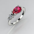 Pear shaped ruby and two diamond asymmetrical Comet engagement ring in 18ct white gold, angled view showing two diamond accents