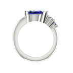 Pear shaped blue sapphire and diamond asymmetrical Comet engagement ring in 18ct white gold, front view showing diamond and sapphire accent detail