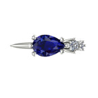 Pear shaped blue sapphire and two diamond asymmetrical Comet engagement ring in 18ct white gold, top view showing east-west setting