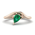 Enchanted pear-shaped lab-grown emerald asymmetrical solitaire engagement ring top-down view — showing asymmetric setting and pear stone orientation in rose gold by Nude Jewellery