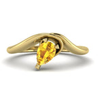 Enchanted pear-shaped yellow sapphire asymmetrical solitaire engagement ring top-down view — showing asymmetric setting and pear stone orientation in yellow gold by Nude Jewellery