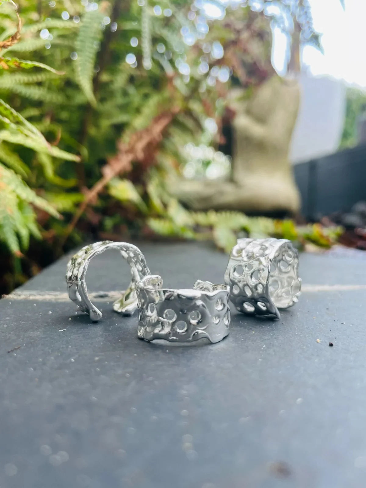 Origin Honeycomb Cuff Ring in recycled sterling silver styled on slate among ferns