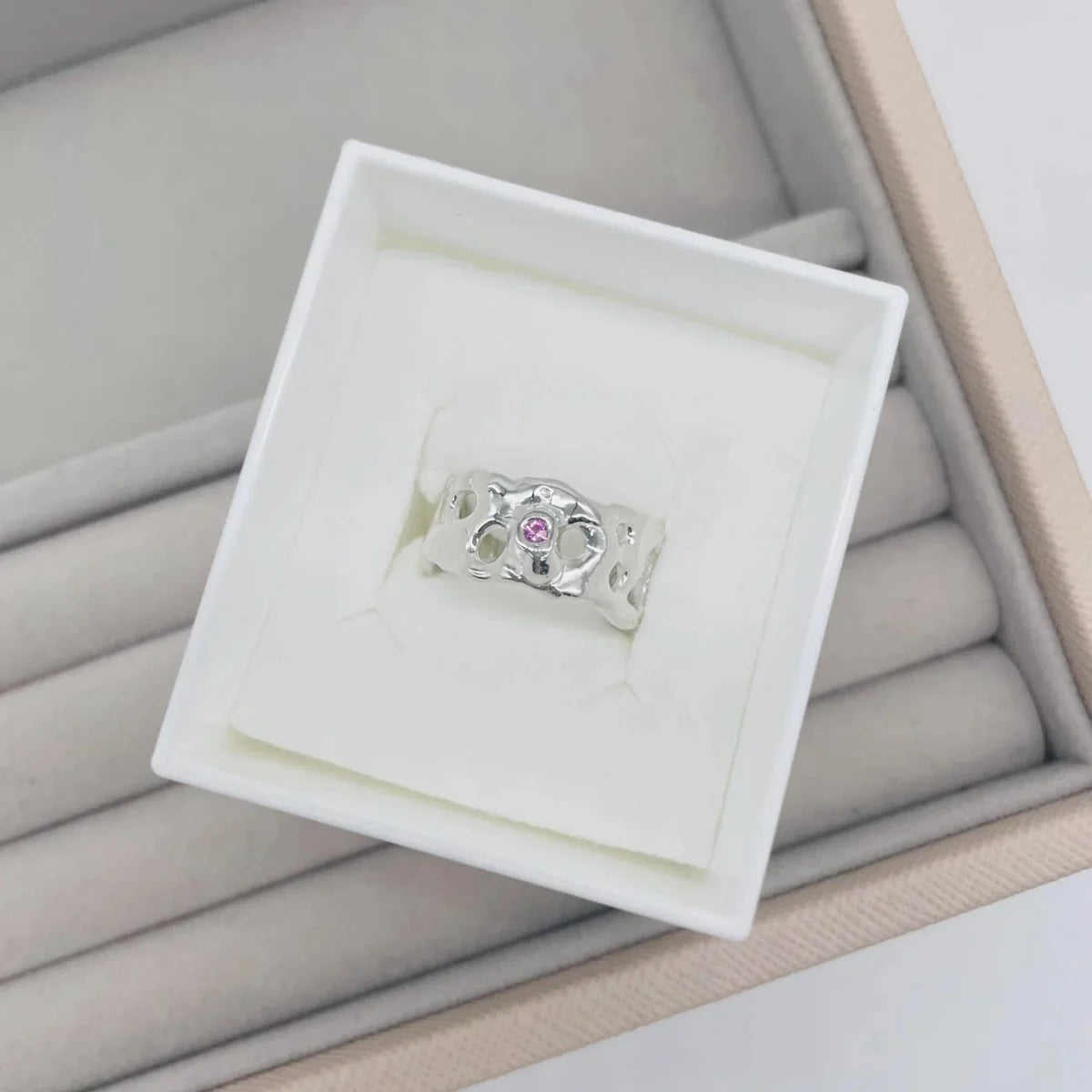 Origin Honeycomb Ring with a pink sapphire in recycled sterling silver, presented in a Nude Jewellery box
