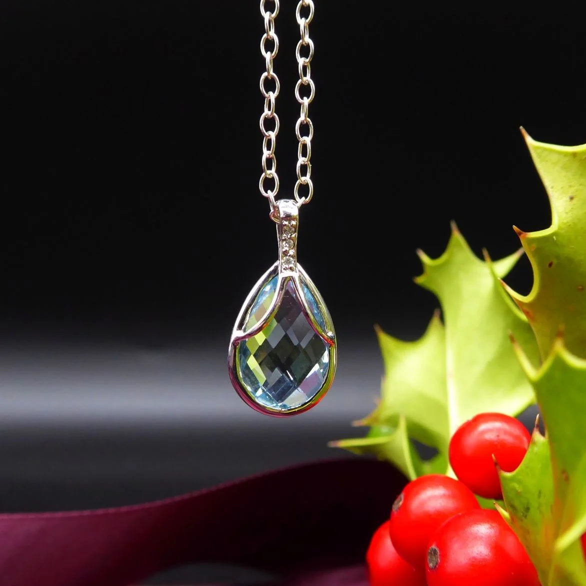 Front view of a pear-shaped aquamarine and diamond pendant in 18ct white gold.