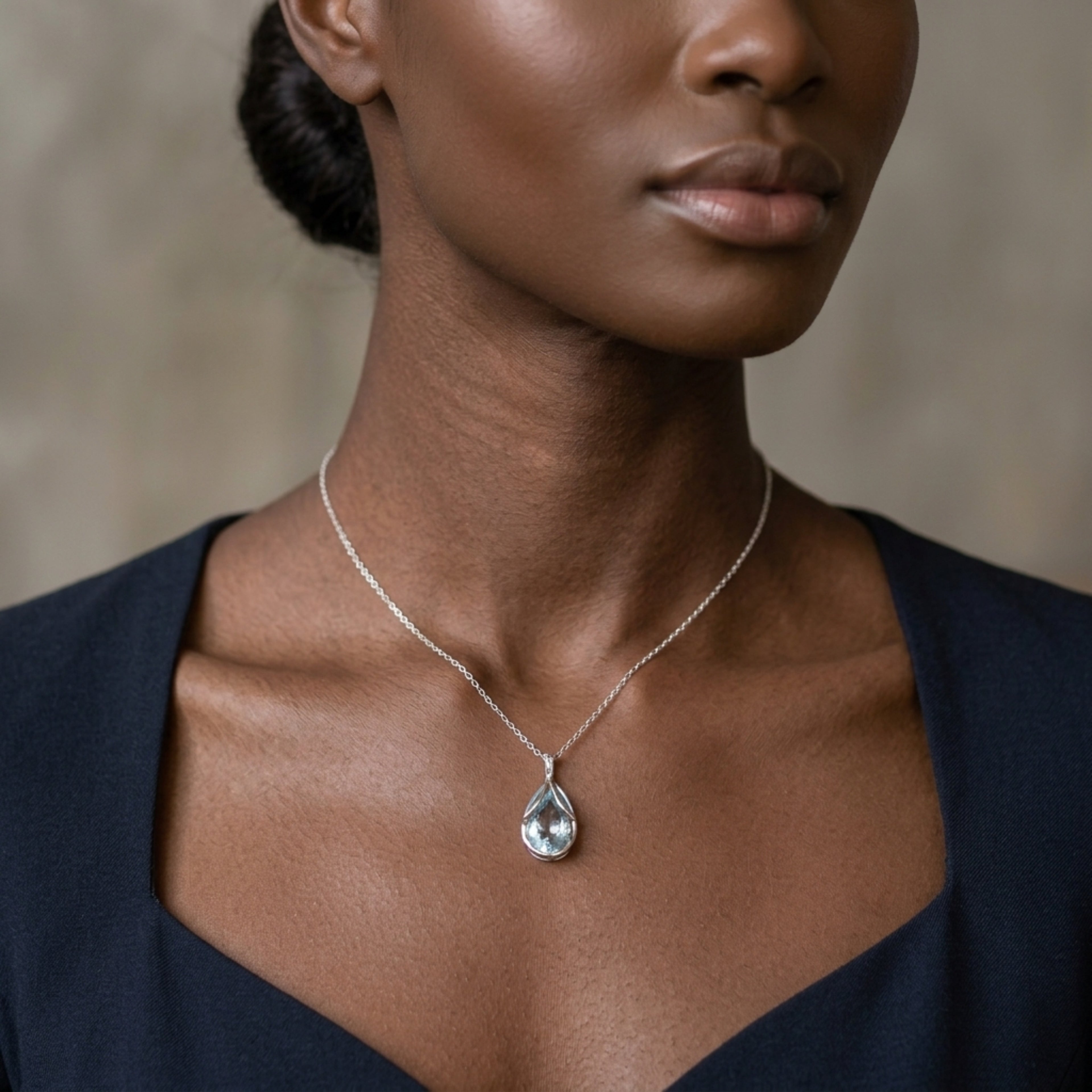 A model wearing the pear-shaped aquamarine and diamond 18ct white gold necklace.