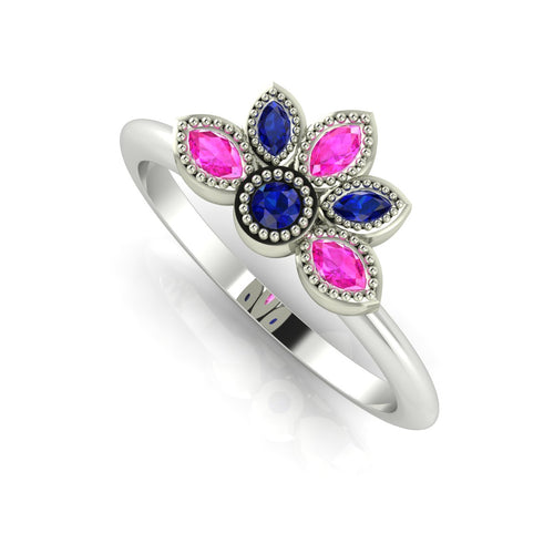 Angled perspective of a pink and blue sapphire cluster ring in white gold with delicate beaded milgrain detailing.
