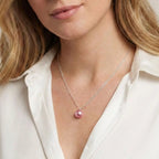 Model wearing a pink freshwater pearl pendant on a sterling silver chain by Nude Jewellery.