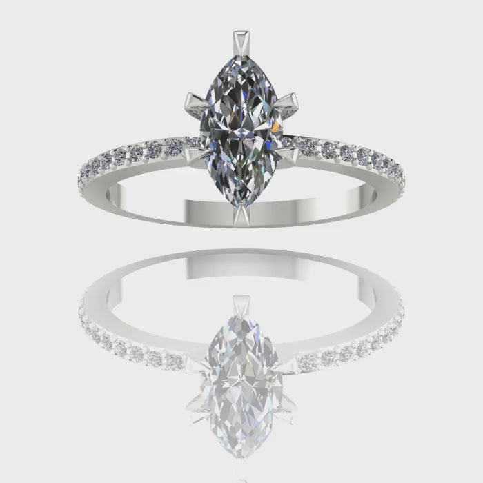 A 360-degree video of the Amoret lab-grown diamond engagement ring in white gold or platinum. The footage showcases the brilliant light return of the sustainable marquise diamond and the pavé-set shoulder diamonds against the cool-toned, high-polish band.