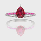 Video of the Calista ruby ring, capturing the rich, fiery shimmer of the red pear centre stone and the bright pink sapphire shoulders against polished white gold or platinum.