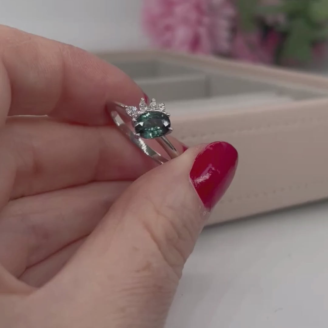 Video of the Selene oval teal sapphire and diamond asymmetric cluster engagement ring — handmade in London by Nude Jewellery