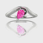 Enchanted pear shaped pink sapphire asymmetric solitaire engagement ring in white gold, rotating 360 view showing sculptural band and vivid pink stone