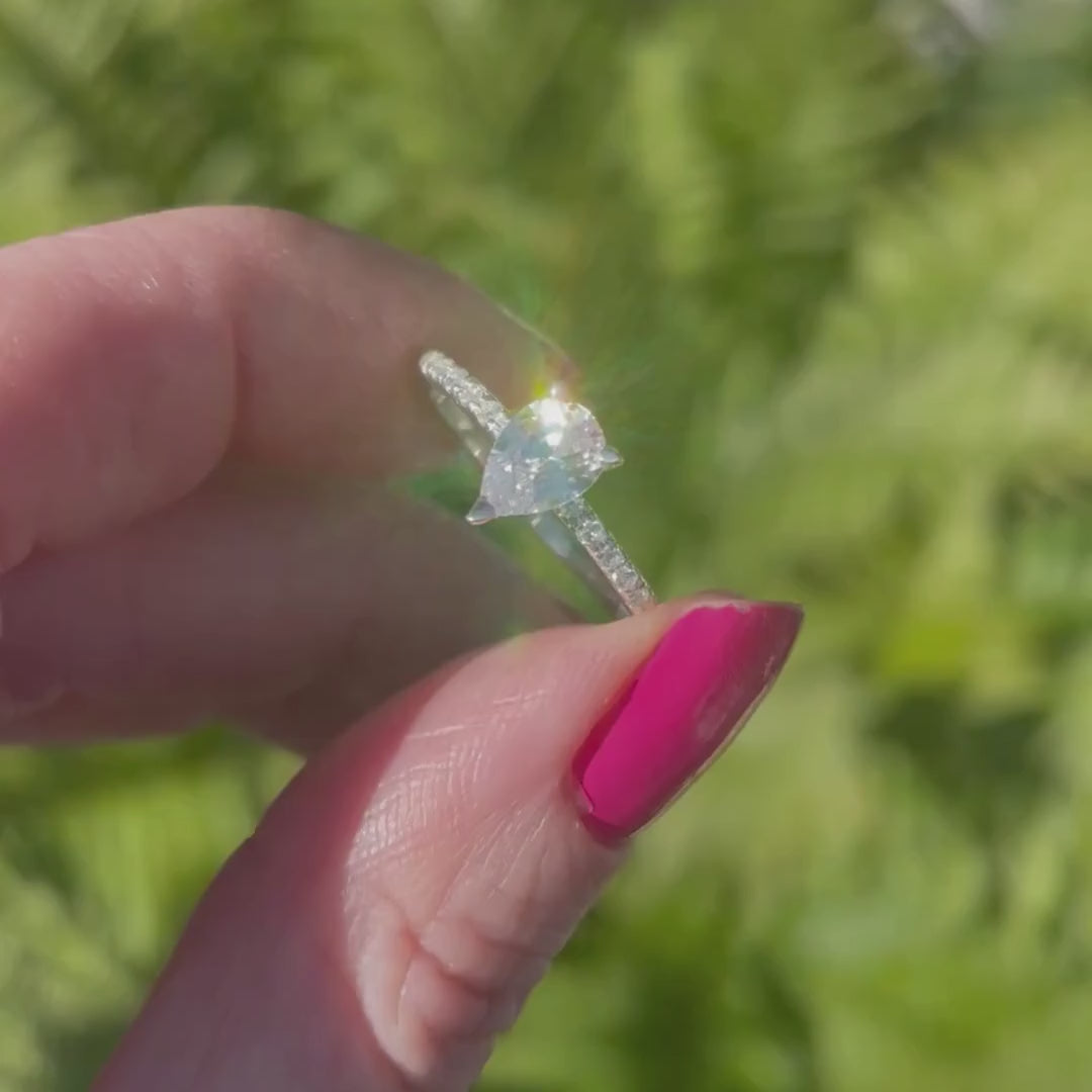Video of the Calista pear-shaped diamond engagement ring in 18ct recycled white gold or platinum — handmade in London by Nude Jewellery