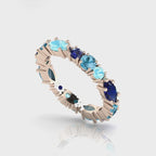 360-degree video of the True Blue eternity ring in 18ct rose gold, showcasing tonal blue sapphires and aquamarines in a bespoke hand-finished setting.