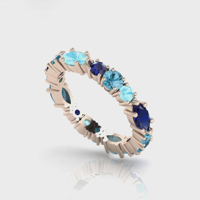 360-degree video of the True Blue eternity ring in 18ct rose gold, showcasing tonal blue sapphires and aquamarines in a bespoke hand-finished setting.