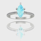 A 360-degree video of the Amoret engagement ring. The footage captures the icy blue light within the central marquise-cut aquamarine and the brilliant sparkle of the diamond-set shoulders as the ring rotates, highlighting the polished white gold finish.