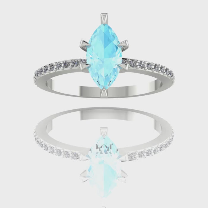 A 360-degree video of the Amoret engagement ring. The footage captures the icy blue light within the central marquise-cut aquamarine and the brilliant sparkle of the diamond-set shoulders as the ring rotates, highlighting the polished white gold finish.