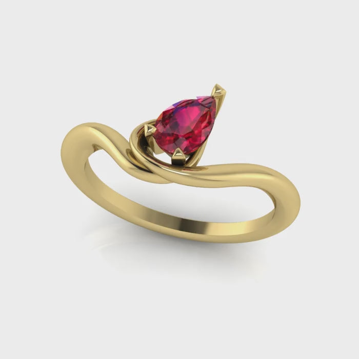 Enchanted pear shaped ruby asymmetric solitaire engagement ring in yellow gold, rotating 360 view showing sculptural band and vivid red ruby