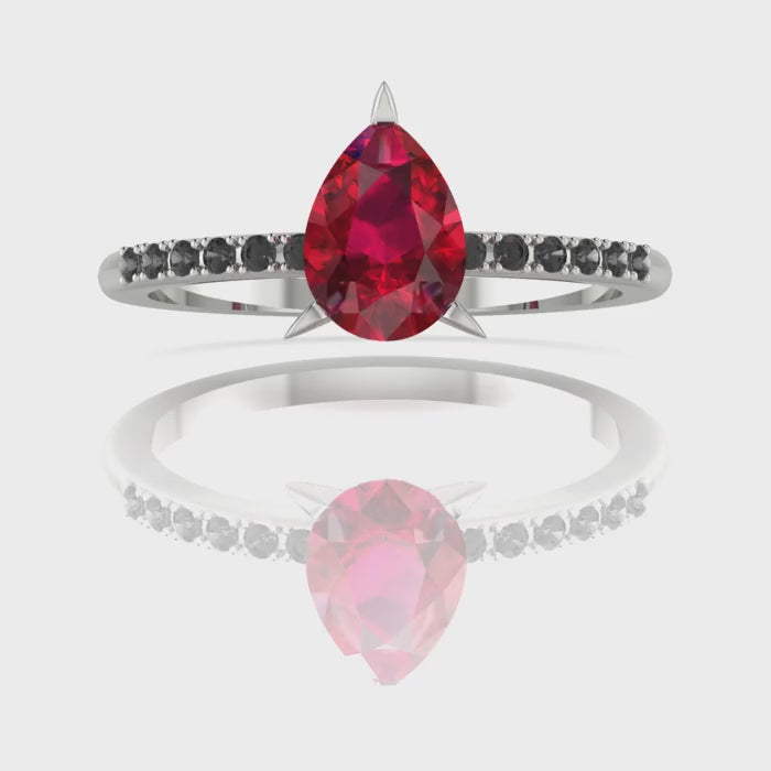 Video of the Calista ruby ring, capturing the deep crimson colour of the pear centre stone and its contrasting pavé black diamond shoulders.