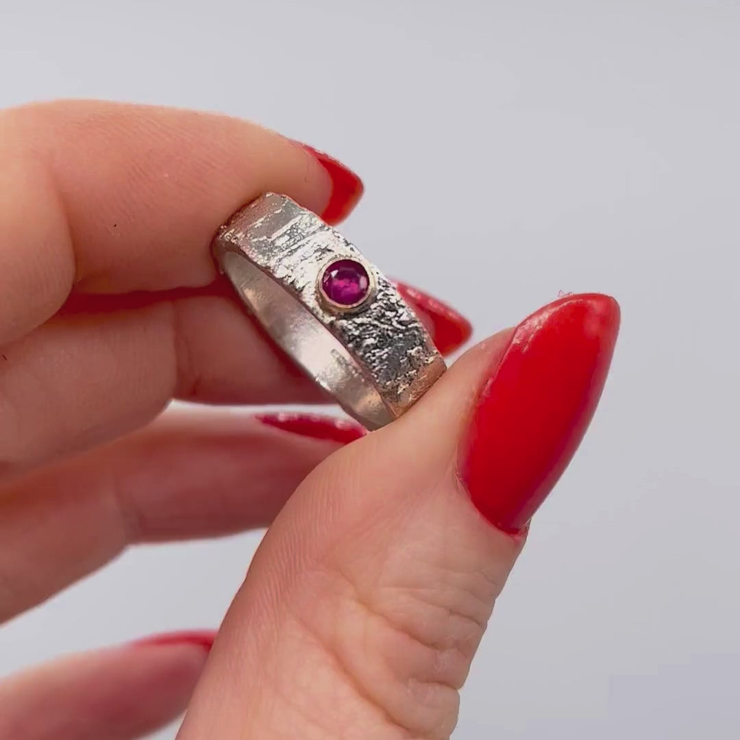 Silver textured ring with a ruby gemstone set in a gold setting movie