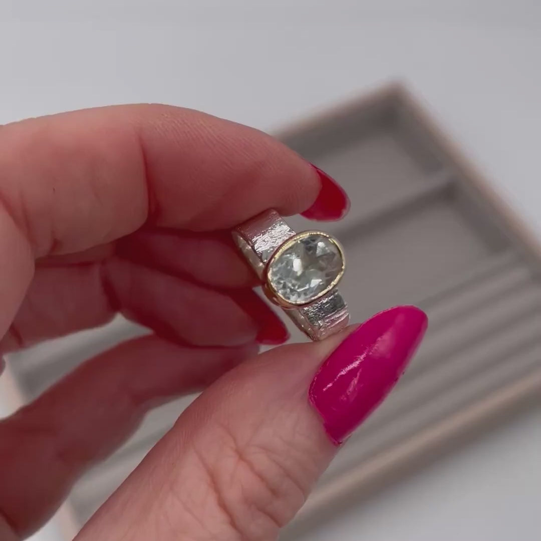 Rivda oval prasiolite ring held to show organic silver texture and stone sparkle