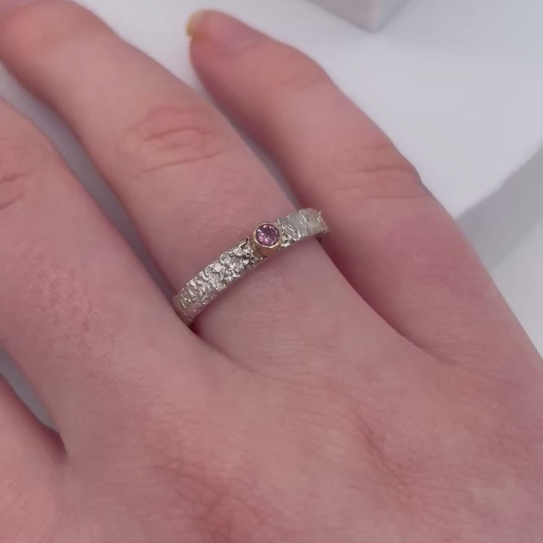 Rivda pink sapphire ring worn on hand showing organic silver texture and stone brilliance