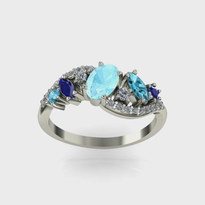 Movie of the angled view of the Atlantis Storm ring highlighting the cluster of blue aquamarine and pavé set diamonds.
