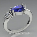 Pear shaped blue sapphire and two diamond asymmetrical Comet engagement ring in 18ct white gold, 360 degree view