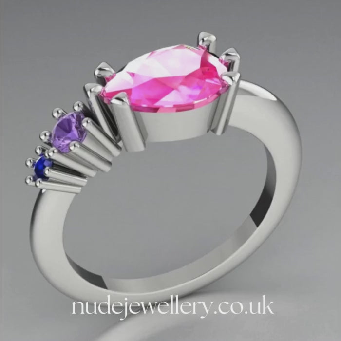 Pear shaped pink sapphire, violet sapphire and blue sapphire asymmetrical Comet engagement ring in 18ct white gold, 360 degree view