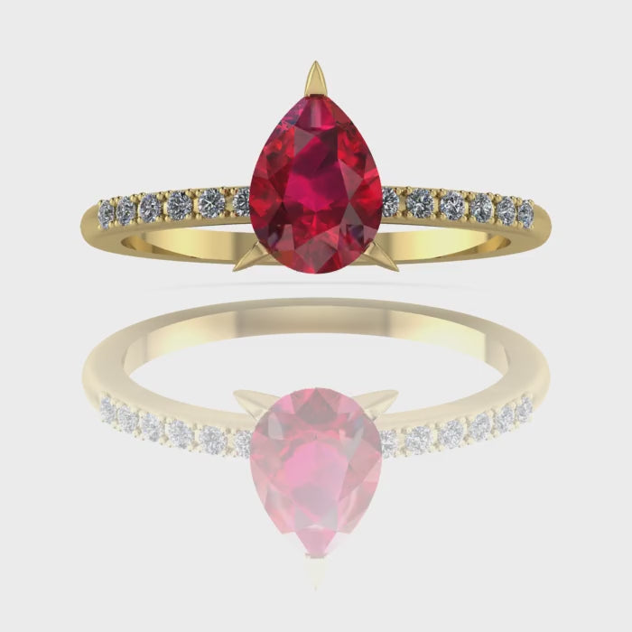 Video of the Calista ruby ring in 18ct yellow gold, capturing the rich, fiery crimson sparkle of the pear centre stone and its brilliant white diamond shoulders.