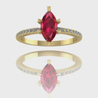 A 360-degree video of the Amoret ruby engagement ring in 18ct yellow gold. The footage highlights the rich crimson hues of the central marquise ruby and the sparkle of the brilliant-cut diamond shoulders as the band rotates.