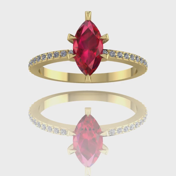 A 360-degree video of the Amoret ruby engagement ring in 18ct yellow gold. The footage highlights the rich crimson hues of the central marquise ruby and the sparkle of the brilliant-cut diamond shoulders as the band rotates.