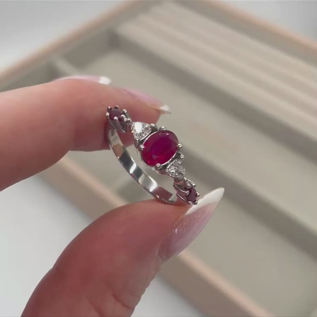 Maisie oval ruby and diamond engagement ring in 18ct white gold or platinum, rotating 360° studio video showing the vivid oval ruby and diamond shoulders, handmade in our London studio
