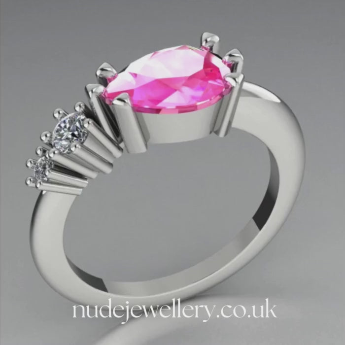 Comet Ring: Pear Shaped Pink Sapphire & Diamond Horizontally Set Trilogy Ring