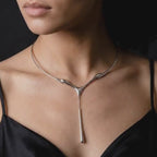 Video featuring the Drip Drop sterling-silver statement necklace, with a sculptural torque collar and elongated fluid drop pendant.