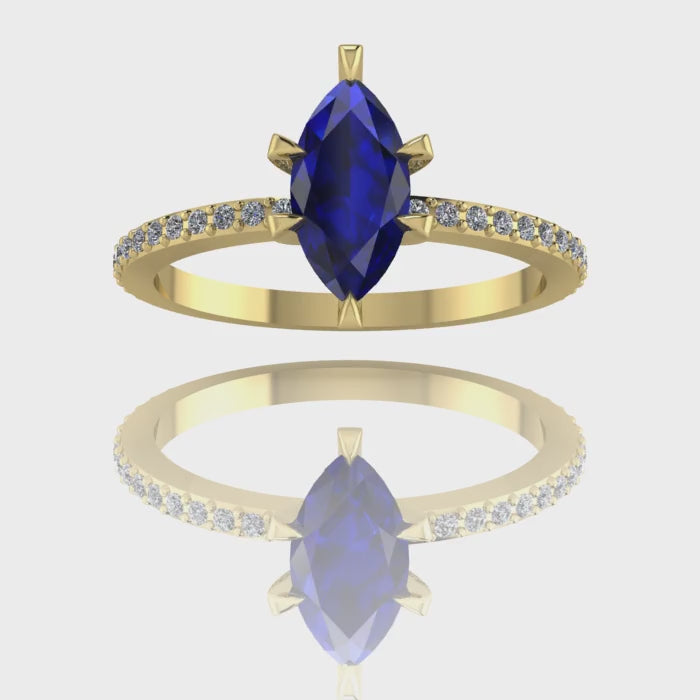 A 360-degree video of the Amoret engagement ring in 18ct yellow gold. The footage showcases the deep blue hues of the central marquise sapphire and the brilliant sparkle of the diamond-set shoulders against the rich golden band.