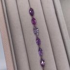 Selection of violet sapphires in various shades, showing gemstone colour options for the Maisie marquise sapphire and diamond ring in white gold or platinum.
