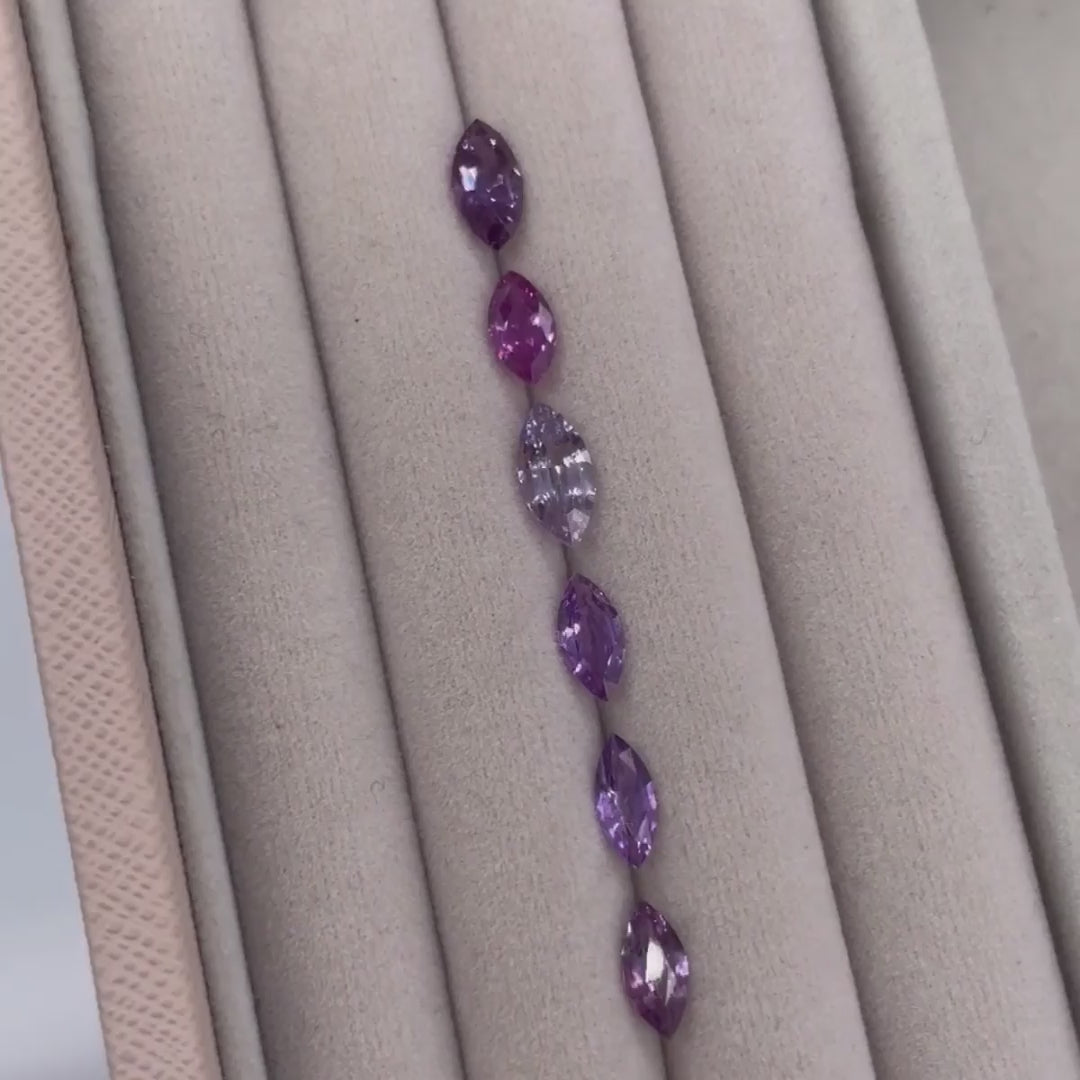 Selection of violet sapphires in various shades, showing gemstone colour options for the Maisie marquise sapphire and diamond ring in white gold or platinum.