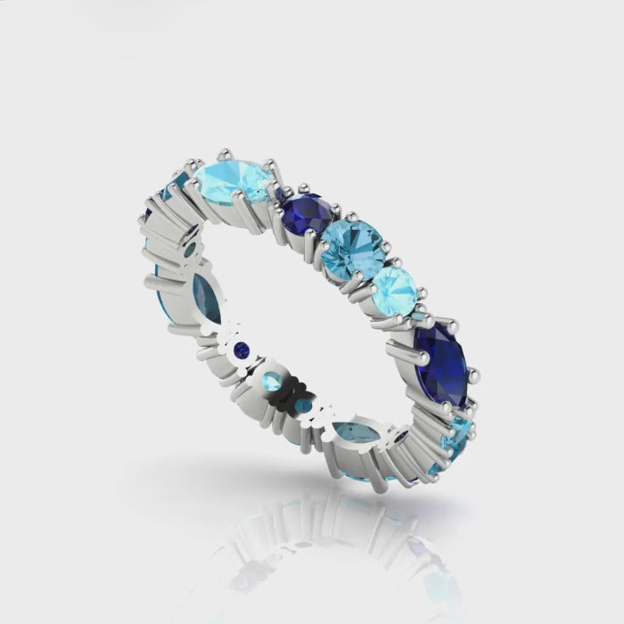 360-degree video of the True Blue eternity ring in 18ct white gold, showcasing tonal blue sapphires and aquamarines in a bespoke hand-finished setting.