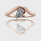 Enchanted pear shaped diamond asymmetric solitaire engagement ring in rose gold, rotating 360 view showing sculptural band and brilliant diamond