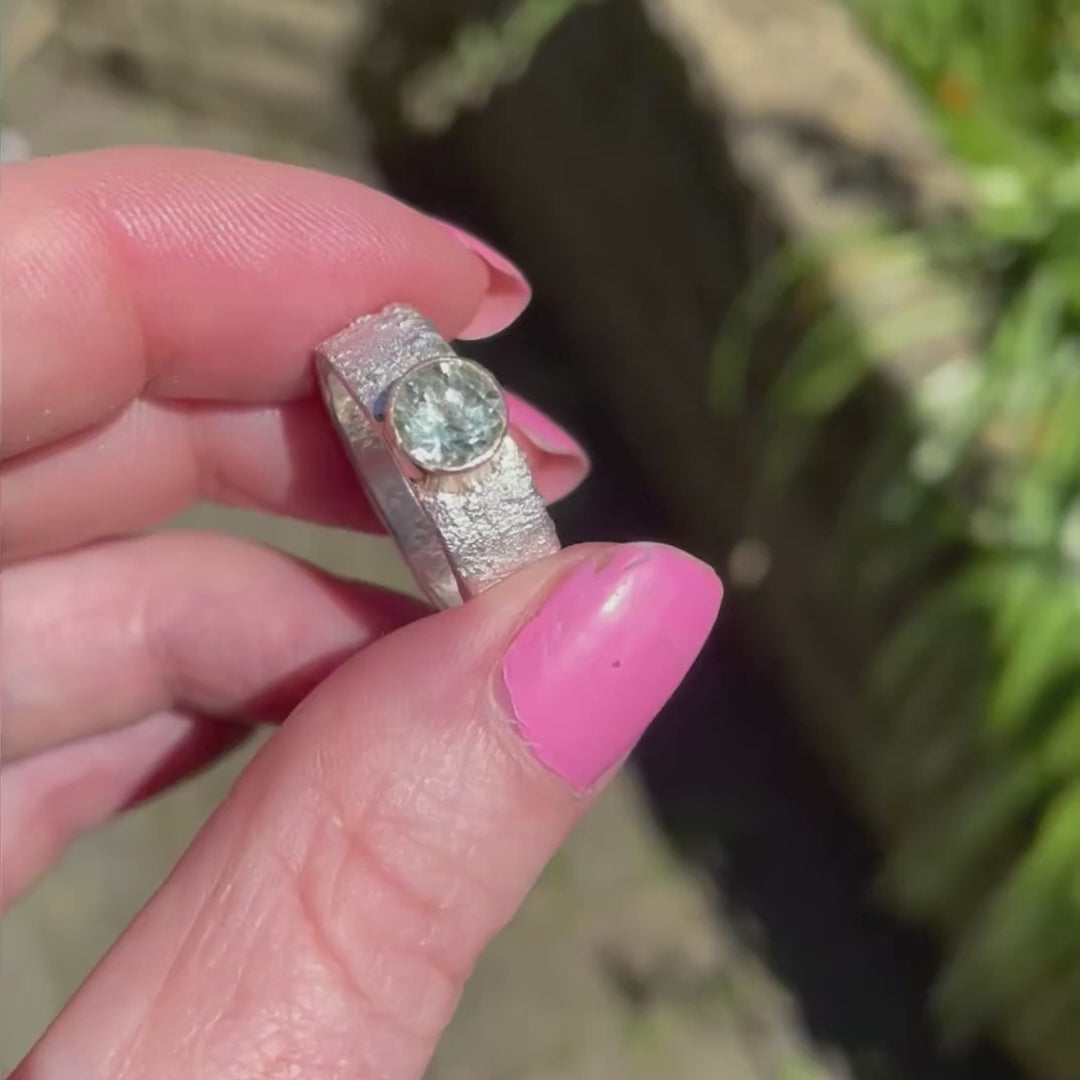 Rivda prasiolite ring held to show organic silver texture and stone brilliance