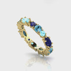 360-degree video of the True Blue eternity ring in 18ct yellow gold, showcasing a vibrant combination of tonal blue sapphires and aquamarines in a bespoke hand-finished setting