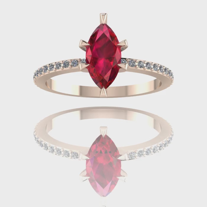 A 360-degree video of the Amoret ruby engagement ring in 18ct rose gold. The footage captures the deep crimson facets of the marquise ruby and the shimmering diamond-set shoulders as the band rotates.
