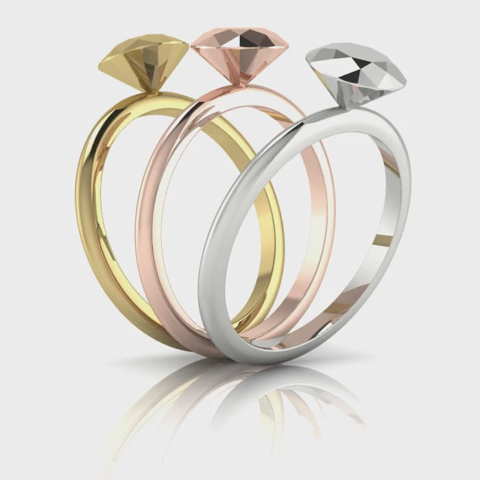 A close-up video showcase of the 7mm solid 9ct rose gold rock solitaire, rotating to capture the warm, copper-toned reflections on the hand-carved facets.