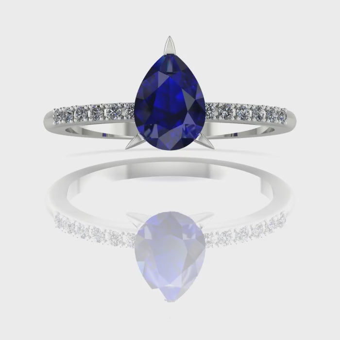 Video of the Calista blue sapphire ring, capturing the velvety midnight-blue shimmer of the pear centre stone and its sparkling white diamond shoulders.