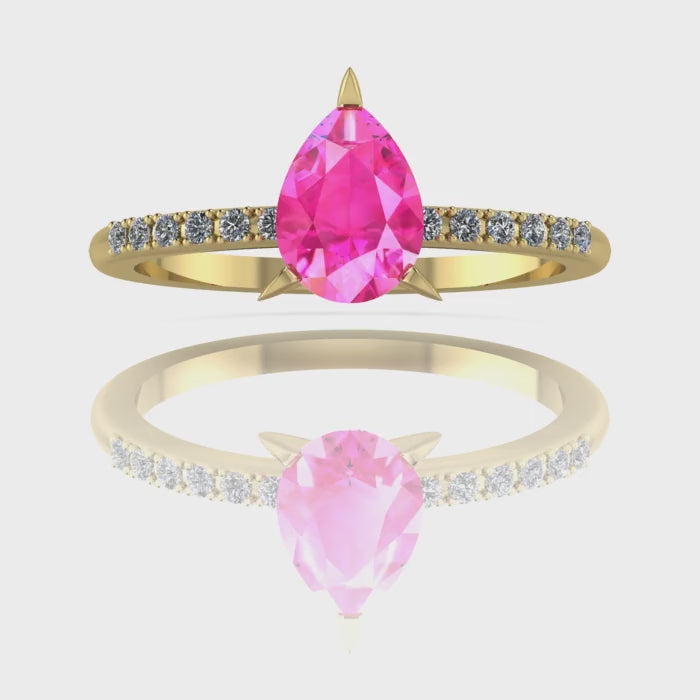 Video of the Calista pink sapphire ring in 18ct yellow gold, capturing the bright, vivid shimmer of the pear centre stone and its sparkling white diamond shoulders.