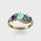 Video of the Atlantis Storm aquamarine, blue sapphire and zircon asymmetric cluster engagement ring in 18ct recycled yellow gold — handmade in London by Nude Jewellery