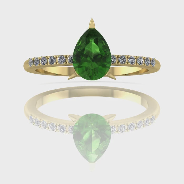 Video of the Calista green tourmaline ring in 18ct yellow gold, capturing the deep forest-green shimmer of the pear centre stone and its brilliant white diamond shoulders.