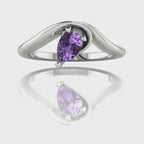 Enchanted pear shaped violet sapphire asymmetric solitaire engagement ring in white gold, rotating 360 view showing sculptural band and ethereal lavender stone